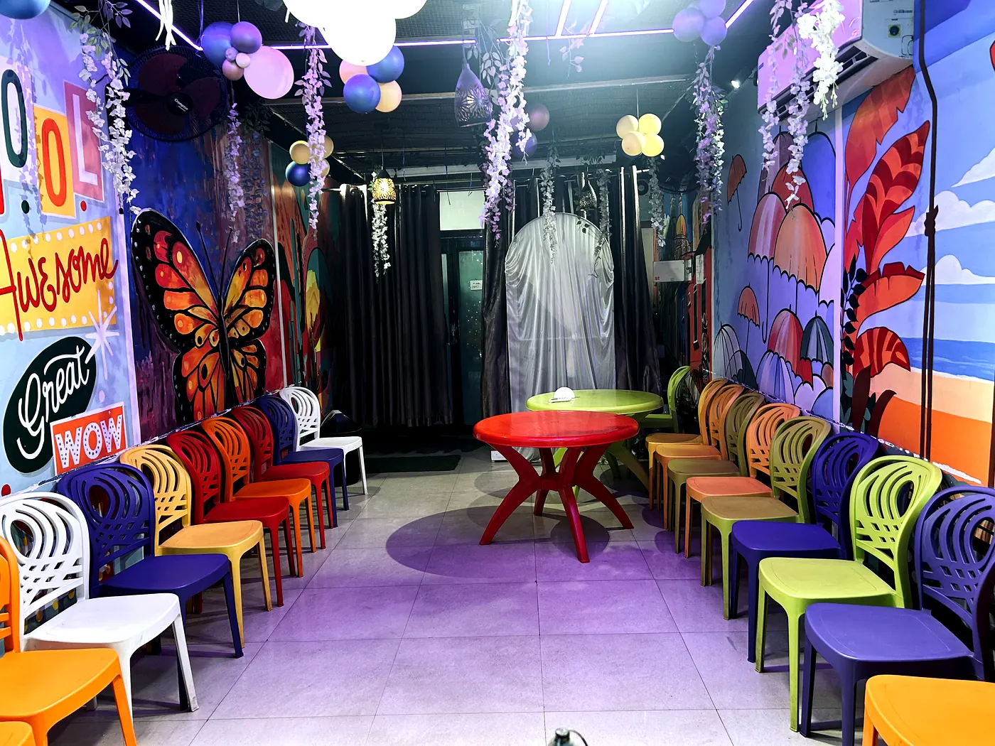 Colourful mural wall and seating inside JD Party Box hall