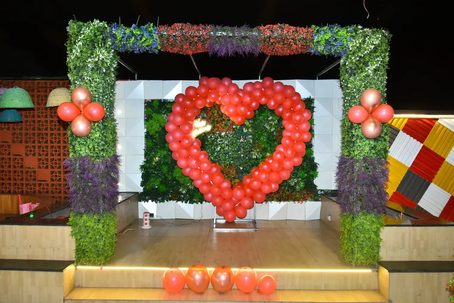 Red heart balloon arch backdrop at JD Sky Dine rooftop